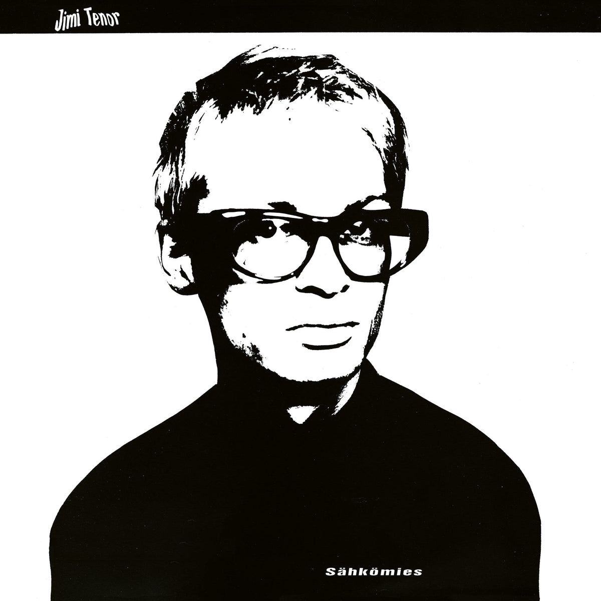 Black and white portrait of a man wearing thick-rimmed glasses.