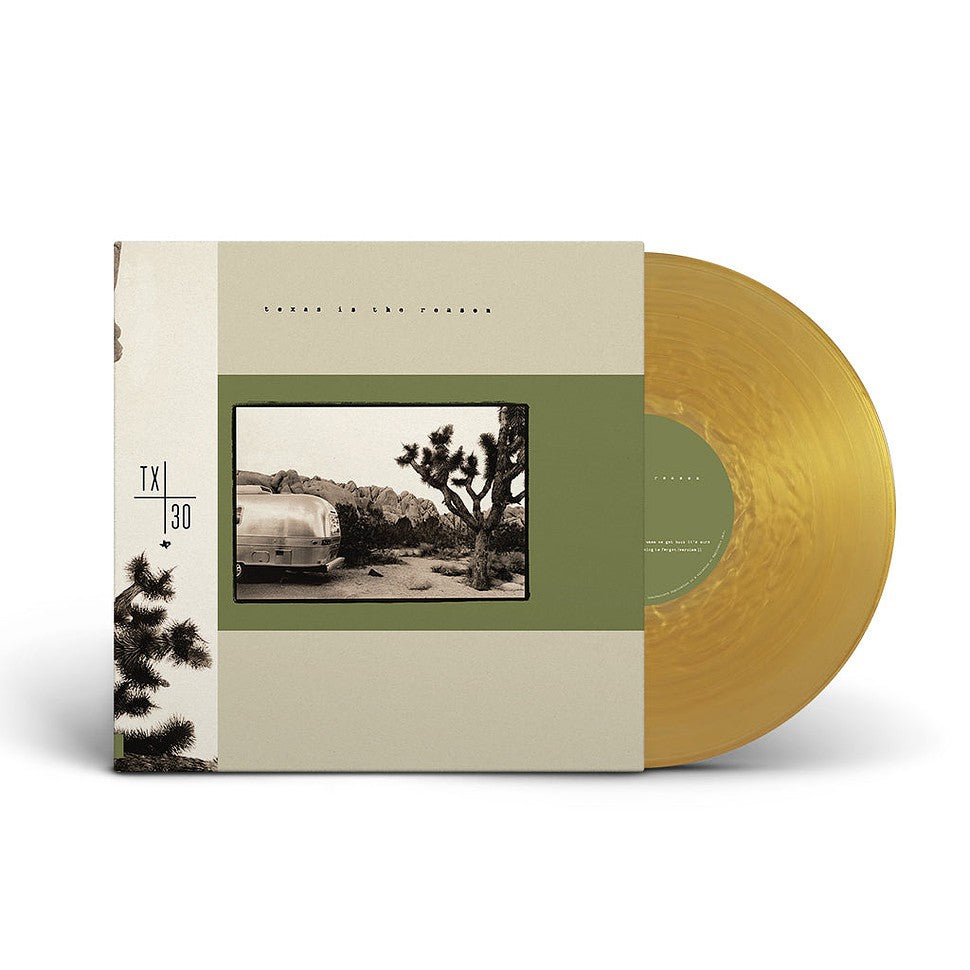 Vinyl record with green tint and album cover featuring a desert landscape.