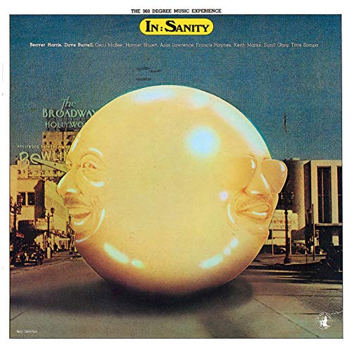 CD cover: two faces merged into a sphere in a city street.