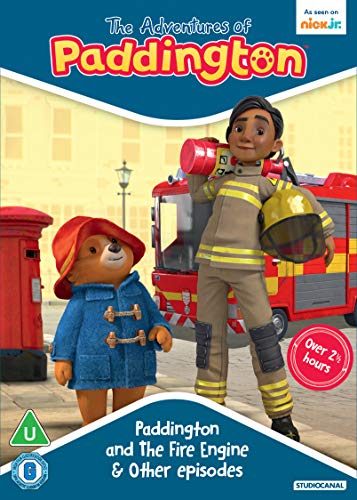 Paddington Bear and a firefighter stand in front of a red fire engine.