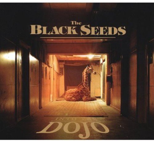 Album cover with giraffe in a dimly lit hallway, titled "The Black Seeds - Into The Dojo".