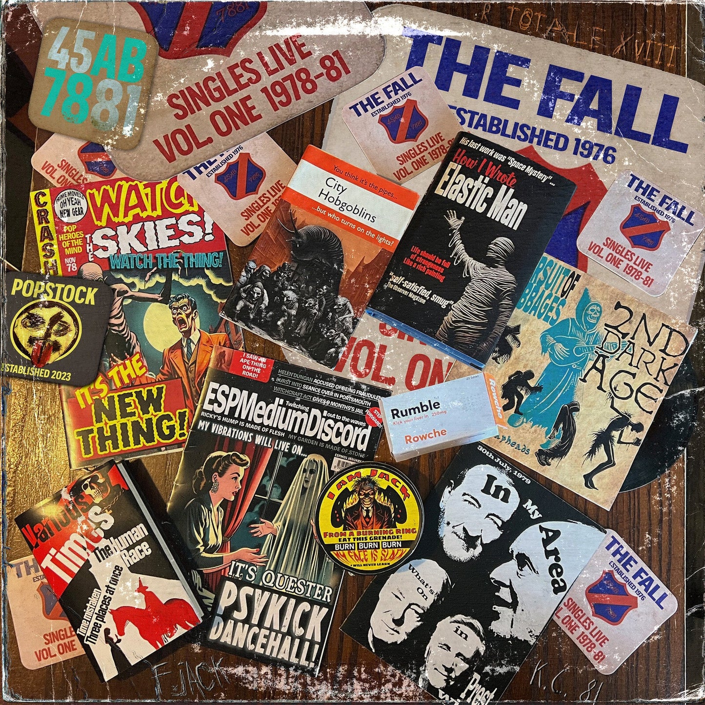 Collage of The Fall band memorabilia including posters, stickers, and album art on wood.