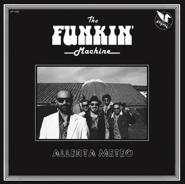 Black and white album cover featuring a band posing in front of a building.