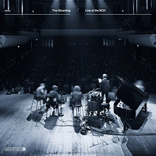 Live music performance with musicians on stage in a concert hall.