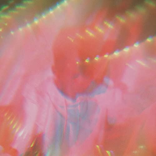 Blurred pink and red album cover featuring a person’s face.