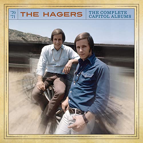 The Hagers twin brothers pose in front of a wooden wagon on this album cover.