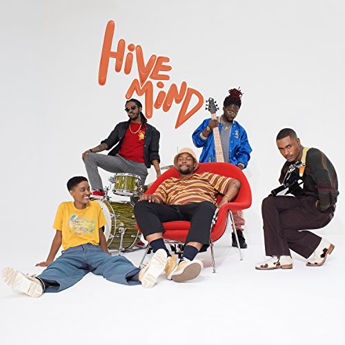 The Internet band members posing with instruments in a studio setting.