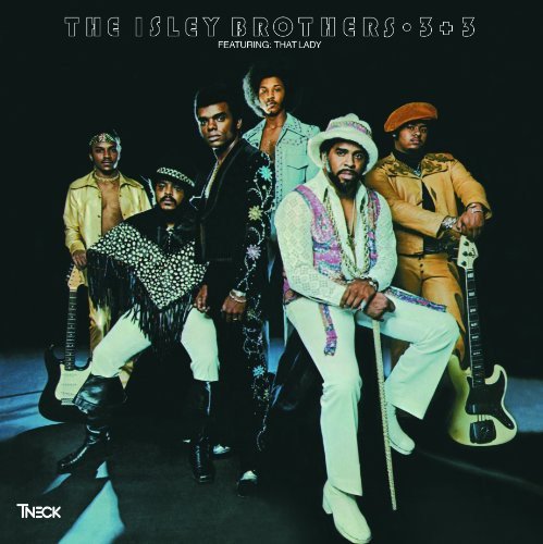 The Isley Brothers posing in stylish 1970s outfits against a solid black background.