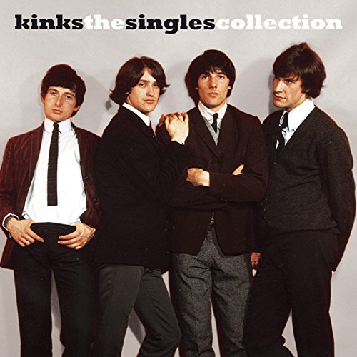 The Kinks standing together in suits against a plain grey background.