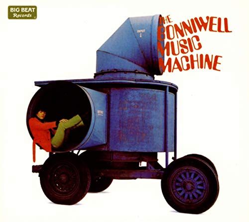 A man in an orange jacket sits inside a blue industrial machine on wheels.
