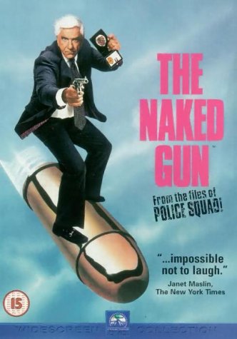 Leslie Nielsen in a suit holding a gun and badge while riding a giant bullet.