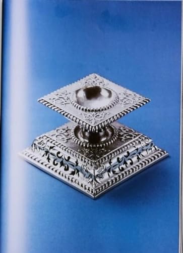 Ornate silver document holder with floral carvings on a blue background.