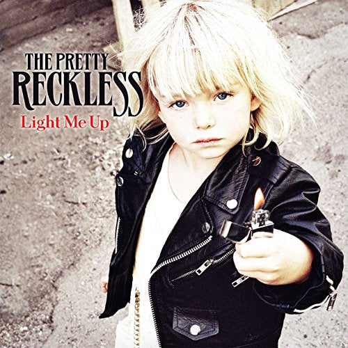 A young blonde girl in a leather jacket holds a lit lighter toward the camera.