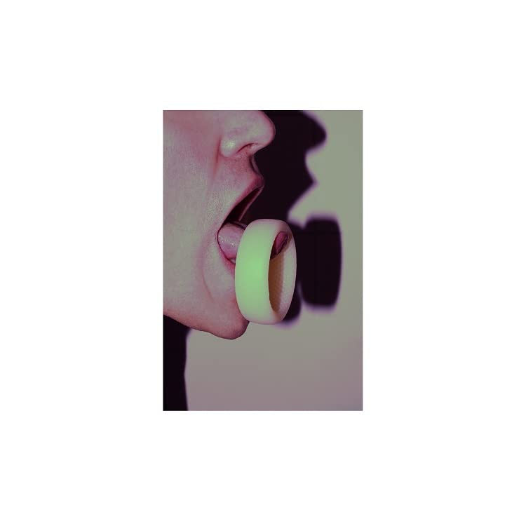 Close-up of a person holding a pale yellow vinyl record in their mouth.