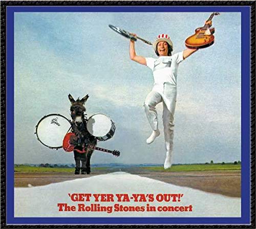 A man in a top hat jumps beside a donkey carrying drums and guitars.
