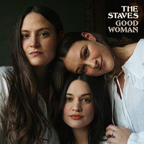 The image shows the album cover for "The Staves - Good Woman". Three women with long dark hair and white shirts are pictured together, looking directly at the camera. The alt text is: "Album cover featuring three women with long dark hair."