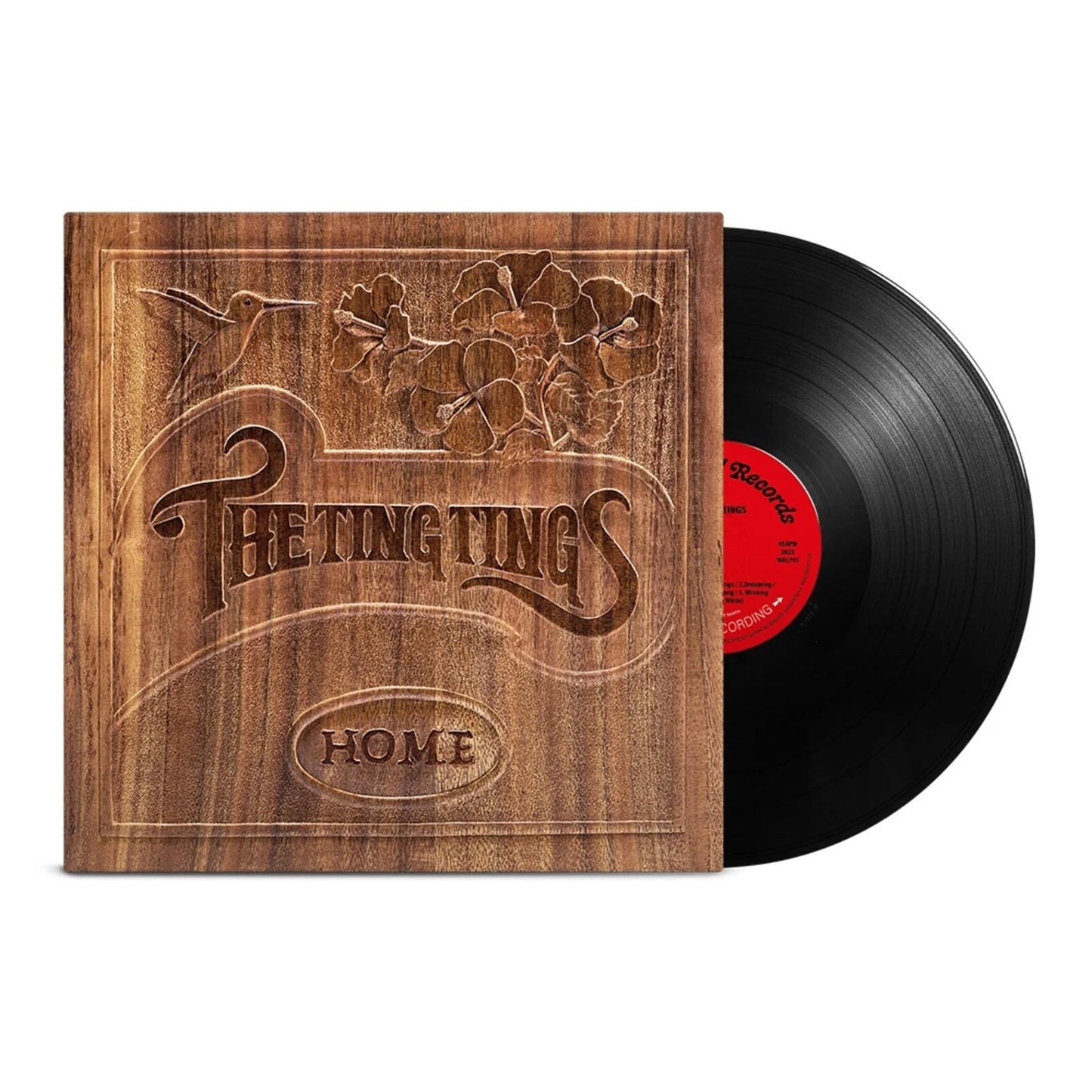Black vinyl record next to a wood-grain album cover featuring a hummingbird and flowers.