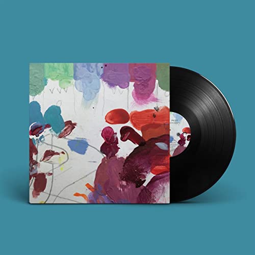 Vinyl record with abstract album art in shades of red, purple, and blue.