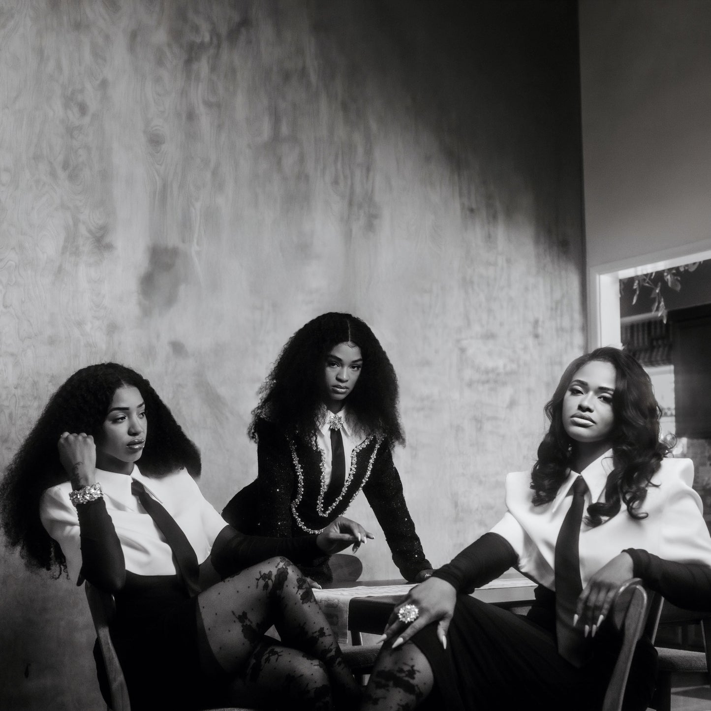 Black and white photo of three women with long, flowing hair.