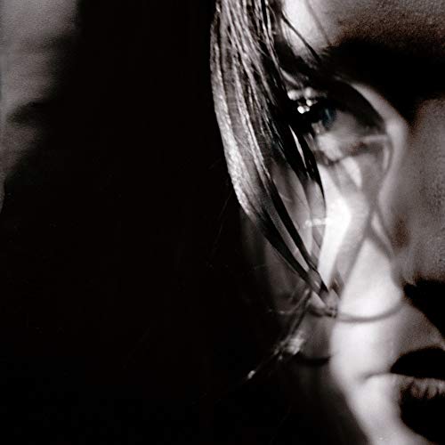 A black and white close-up of a person's face with tears.