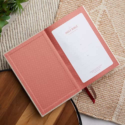 Open blue hardcover Bible with lined pages, a presentation page, and ribbon marker.
