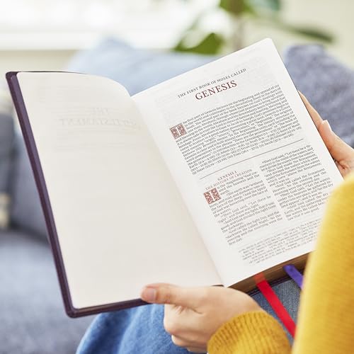 Hands holding an open NKJV Bible showing the beginning of the Book of Genesis.