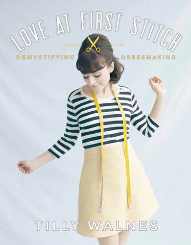 Woman in a striped shirt and yellow skirt wearing a yellow measuring tape.