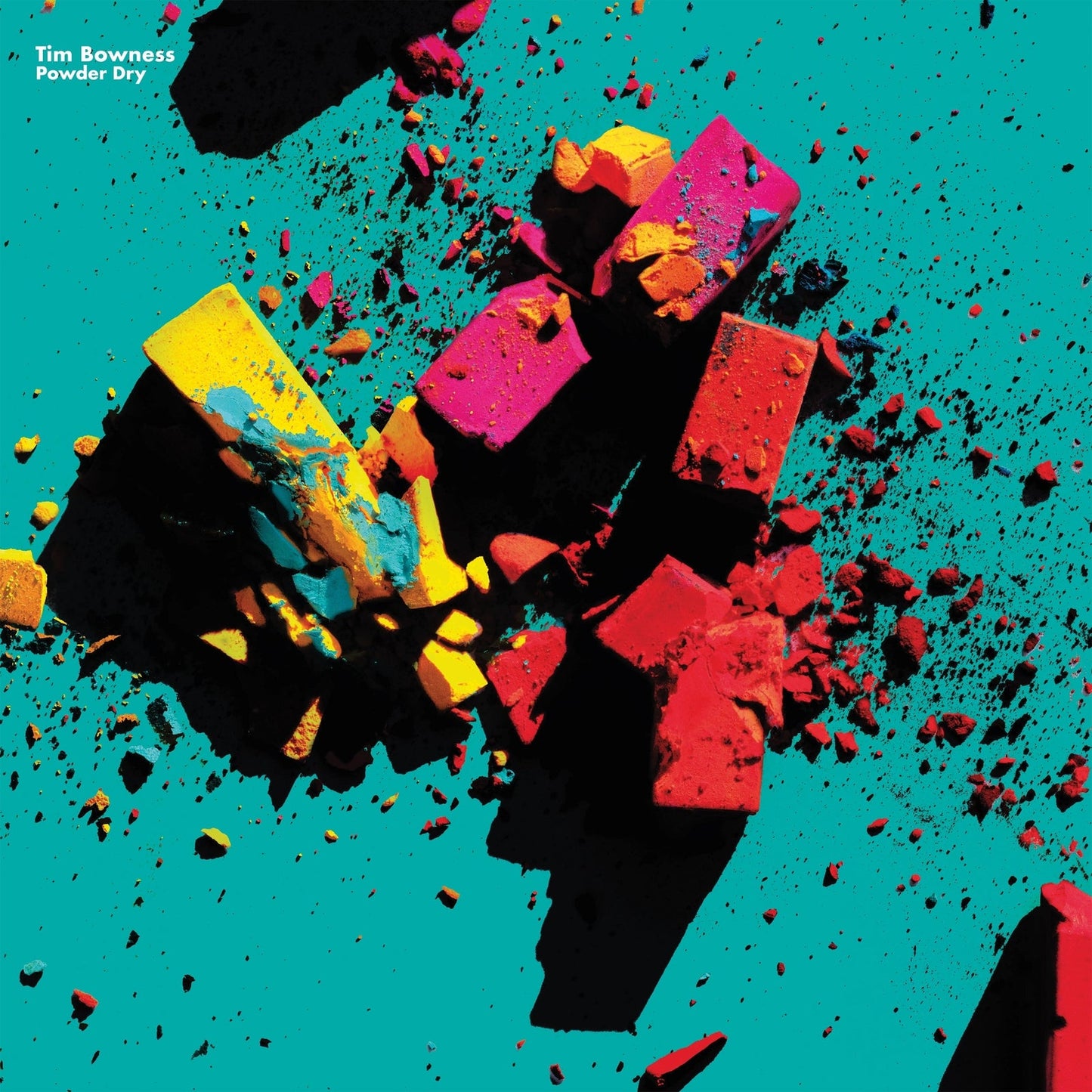 Album cover: colorful, fragmented blocks exploding against a teal background.