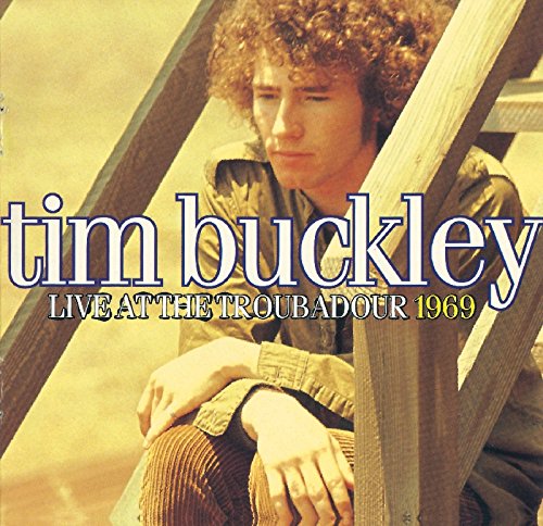 Tim Buckley with curly hair sitting on wooden stairs, album cover art.