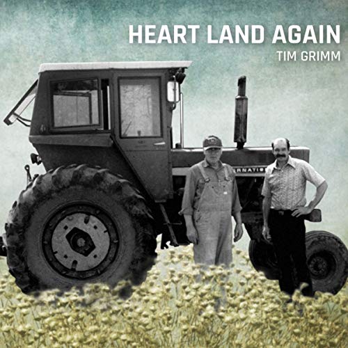 "Album cover with two men standing beside a tractor in a field."