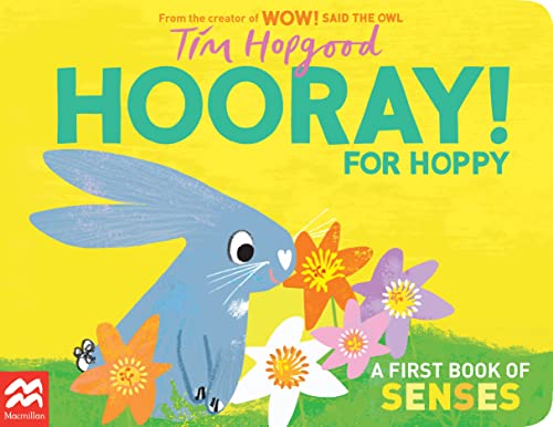 Blue bunny smelling colorful flowers on a bright yellow background.
