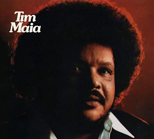 Close-up portrait of Tim Maia with an afro, against a red background.