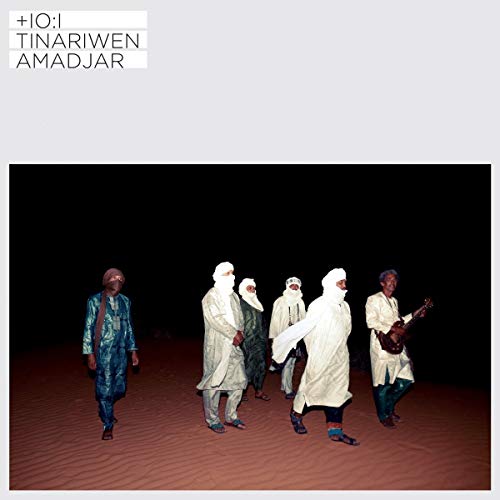 Tinariwen album cover: group of musicians walking in a desert landscape.