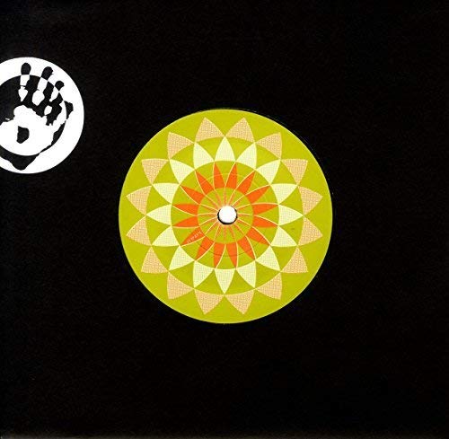 A vinyl record with a green, orange, and beige geometric pattern on a black background.