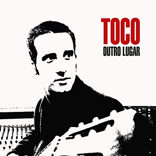 Black and white portrait of a man with a guitar, album art.