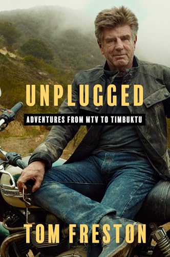 Tom Freston sits on a motorcycle against a misty, mountainous background on his book cover.