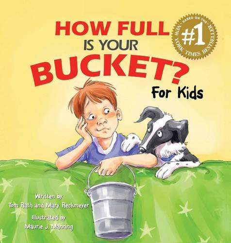 Book cover: boy with dog and a silver bucket on grass.