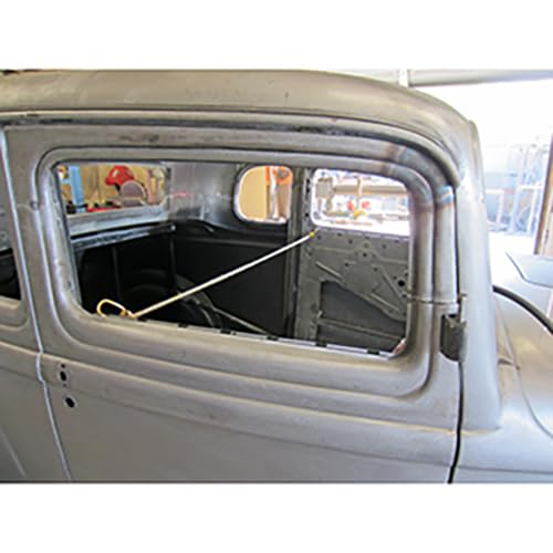 Vintage car with roof being chopped, showing interior frame and window.