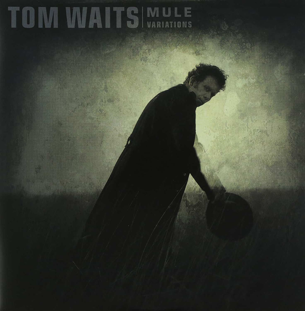 Tom Waits album cover, "Mule Variations", showing a bent figure with a hat.