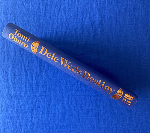 Blue book spine with gold lettering: “Dele Weds Destiny” by Tomi Obaro.