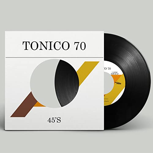 Vinyl record with geometric cover art, featuring black, yellow, and brown shapes.