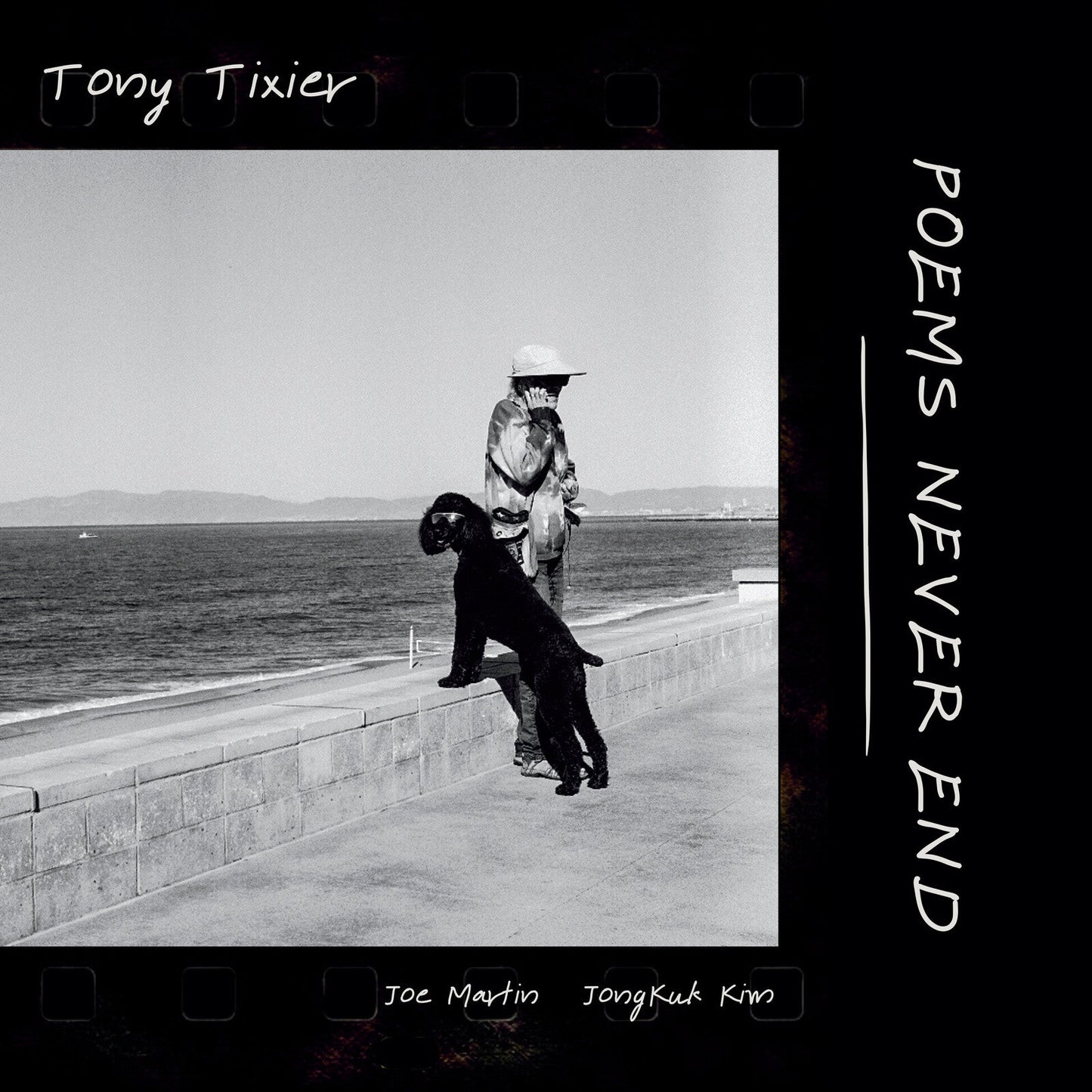 Black and white album cover featuring a person with a dog by the sea.