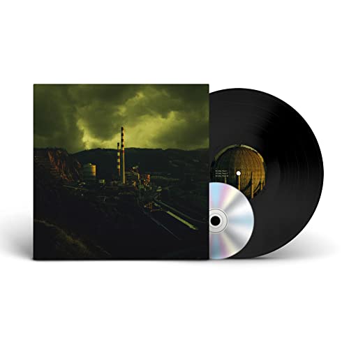 Vinyl record with album art depicting an industrial landscape under a stormy sky.