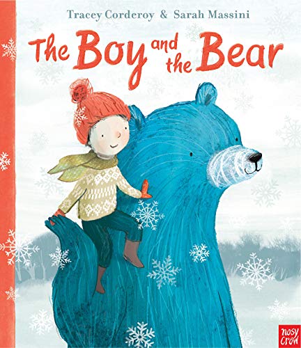 A boy sits on a large blue bear surrounded by snowflakes.