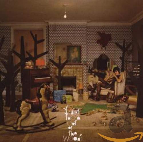 CD cover: woman with rocking horse in a decorated room.