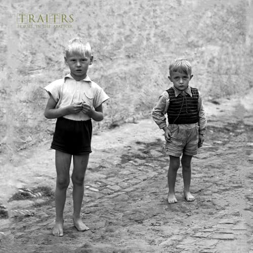 Black and white photo of two young boys standing on a dirt path.