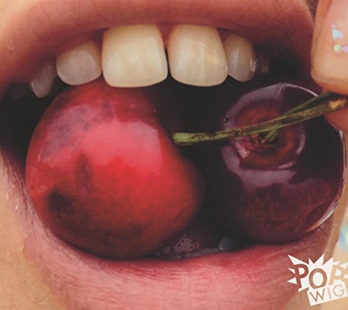 Close-up of lips biting into two dark red cherries on a stem.