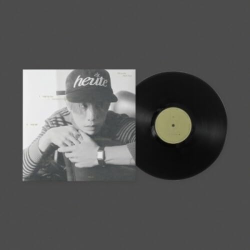 Vinyl record and album cover featuring a portrait of a man in a hat.