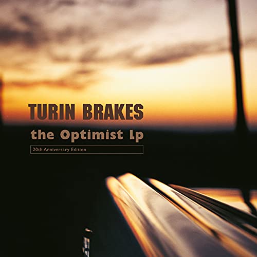 Album cover for Turin Brakes’ “The Optimist LP” with a sunset background.