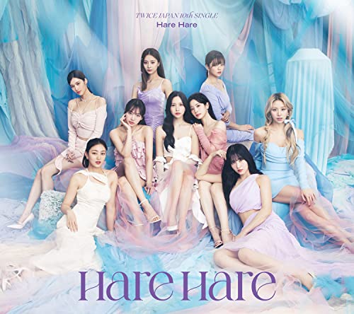 Nine women in pastel dresses pose amidst flowing blue and white fabric.